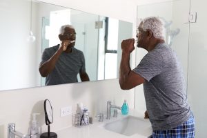 man brushing his teeth in the morning